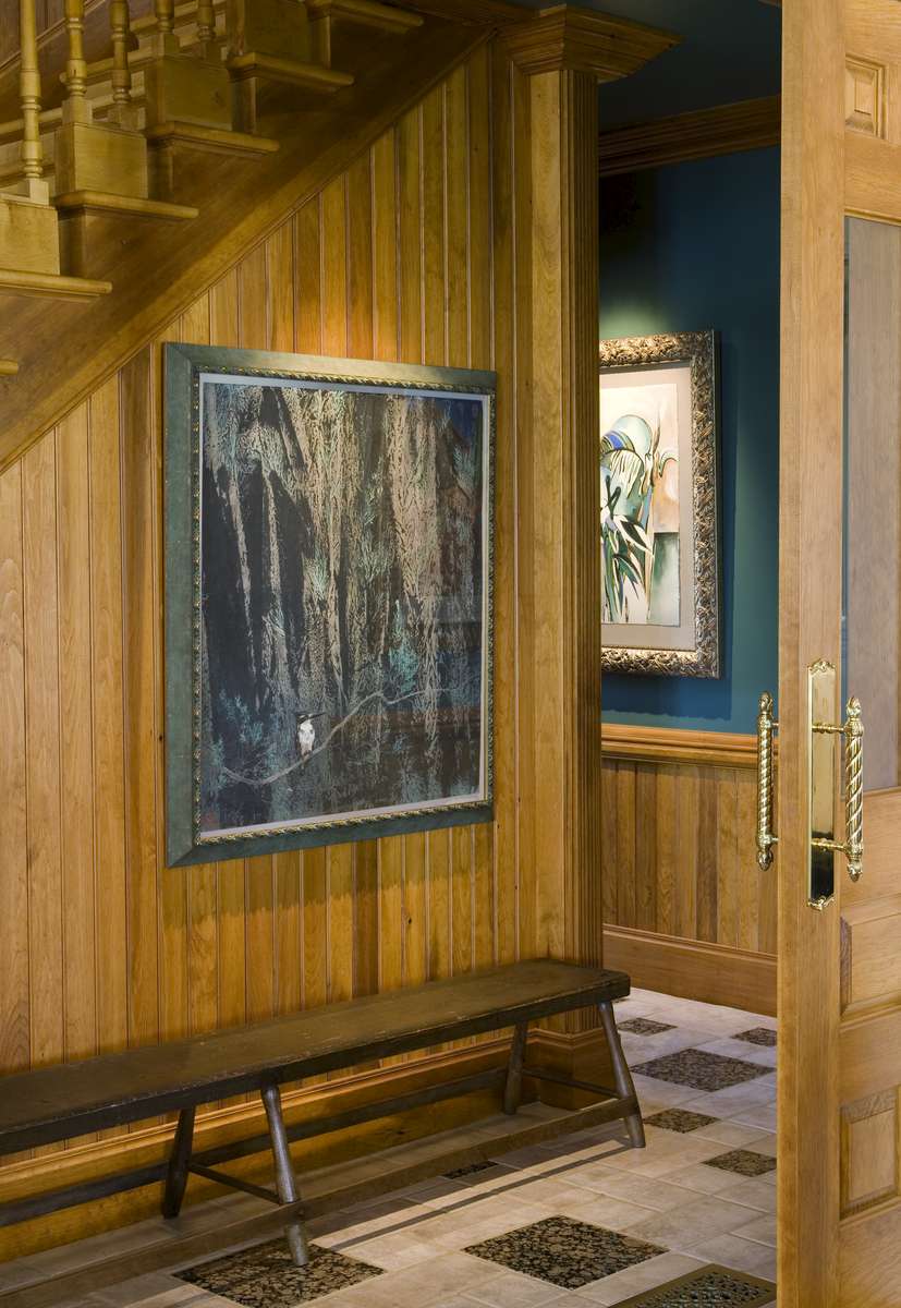A 19th Century bench waits in the hall with a painting collected in China, from a 1987 adventure.  Beyond is a painting from The Outback of Australia, circa 1985.
