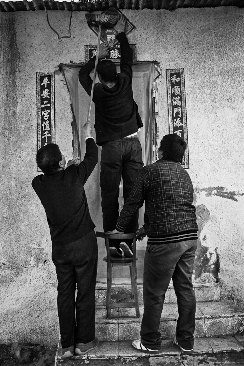 CAIRO, EGYPT - JANUARY 22 : Jingy Ai, Wu Tang and Li Tang decorate the doorway to the Ai residence in reparation for Chinese New Years celebration on January 22, 2012 outside Cairo, Egypt. 