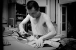 CAIRO, EGYPT - MAY 31 : Wu Qing works at a apartment sweatshop, where he can make about 300 hundred pairs of khakis in one ten hour night, on Medan El Geesh in Cairo, Egypt. 