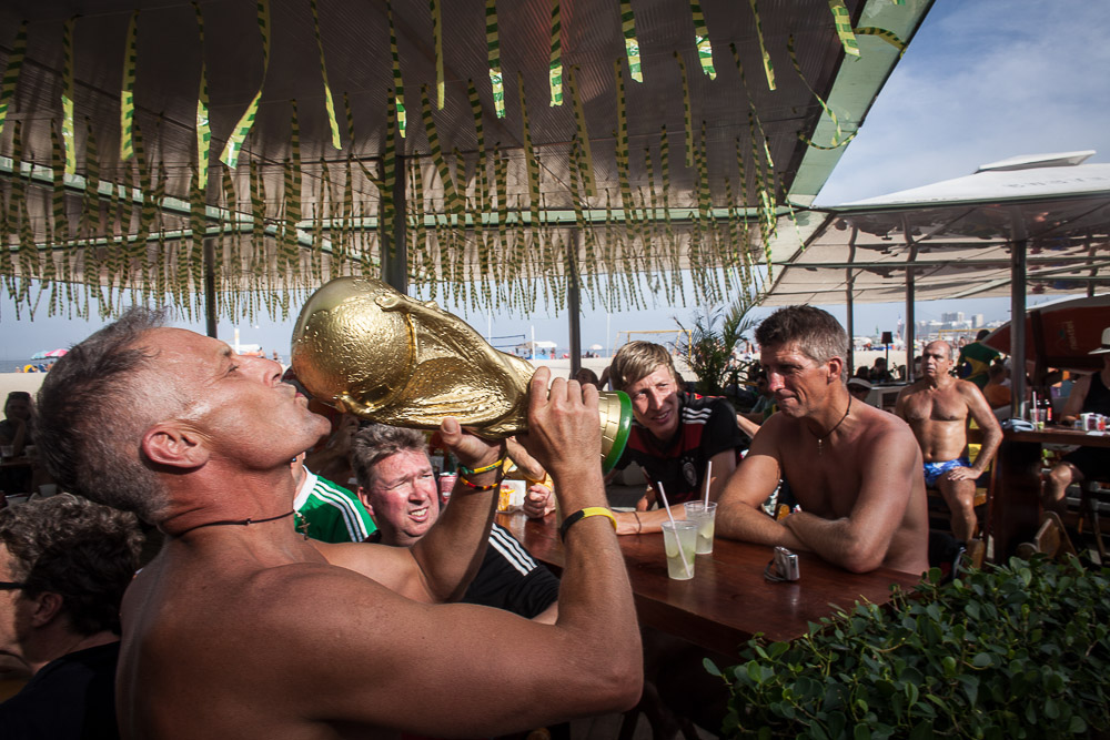 RIO DE JANEIRO, BRAZIL - JUNE 29 : Matthias Muller kisses a fake FIFA World Cup trophy at a kiosk on June 29, 1014, on Copacabana beach in Rio de Janeiro, Brazil. (Photo by Kim Badawi/Global Assignment by Getty Images for Der Spiegel )