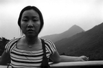 Chi Ying stands on top of Fung Wong Shan Peak Overlooking Hong Kong.Hong Kong Island