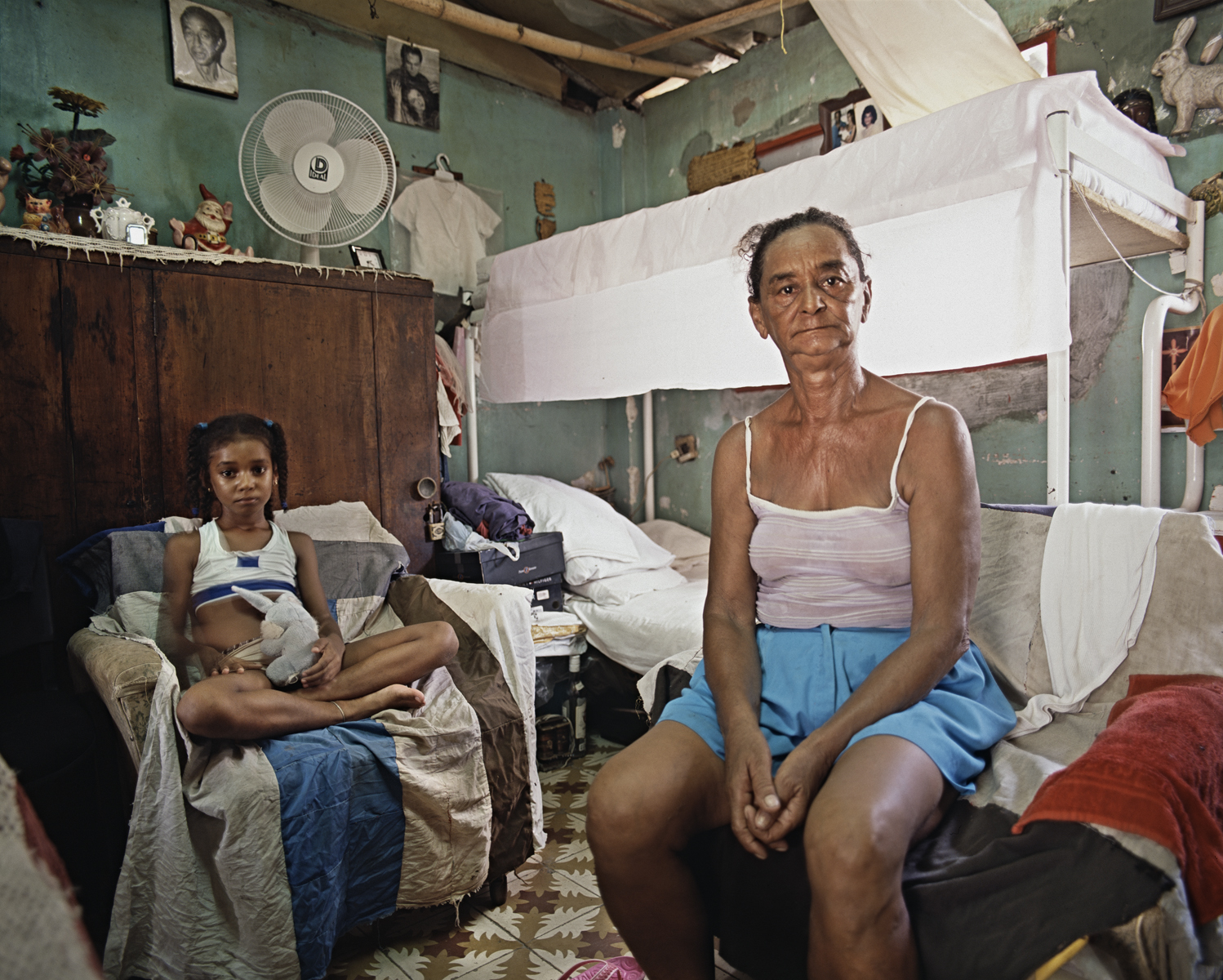 Anaidis and her grandmother, Fermina, sit for their portrait inside their home. Mantilla, Havana, Cuba