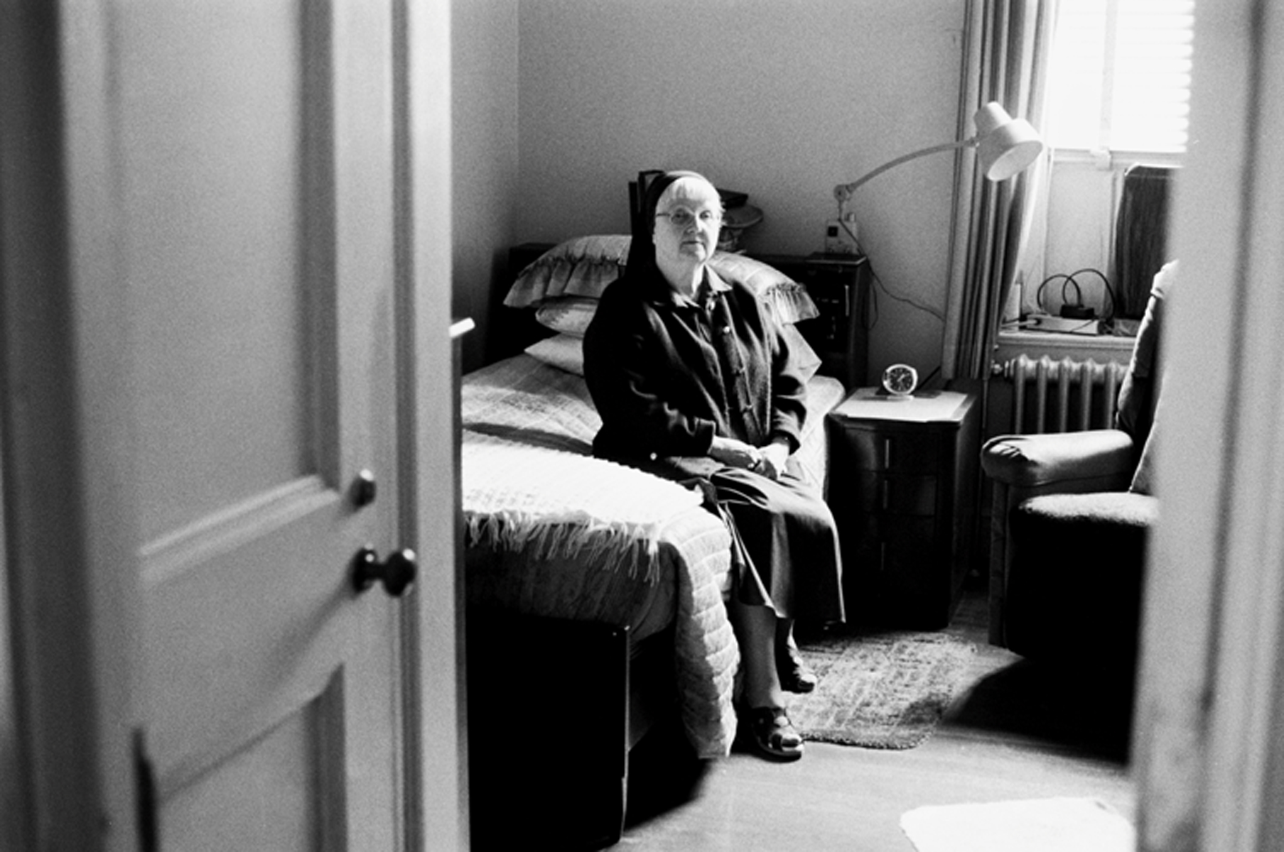 Sister Nina, a Daughter of Charity, sits in her room praying. 