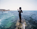 As the dog days of summer set in, a teenage girl escapes her reality by having fun swimming with the boys. She was the only girl jumping off the jetty, as most girls tend to stay inside their homes, helping their mothers or grandmothers with cooking or cleaning the house. Cojimar, Cuba