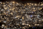 A night view of the front side of the Shantytown of Rocinha, in Rio de Janeiro, Brazil, December 4, 2012.With a population of between 120 and 150,000 people, Rocinha is the largest favela in Rio de Janeiro.After being pacified in November 2011, Rocinha remains to be one of the comunities creating more controversy because of its size and its old connections to drug trafficking.While many believe that UPPs have helped quell violence by opening the doors of the favelas to public services such as legal electricity supply, garbage collection, education, public works and social assistance program, others see the pacification program as a temporary cover-up to security problems in Rio de Janeiro. 
