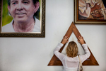 A woman praying close to the portrait of Joao Teixeira de Faria, known as John of God (Joao de Deus), in Abadiania, Brazil, October 31st, 2012. De Faria is the worlds´ most famous spiritualist {quote}miracle man”. Numerous people join together to pray and to be attended by him in the house of Ignacio de Loyola, his healing center in Abadiania, 120 kilometers west of Brasília.An estimated number of 3.000 people from all over the world are attended by Teixeira de Faria per week.