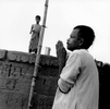 A Hindu man does his daily prayers atop one of the 100 ghats that line the west bank of the Ganges Rver.Varanasi, India 1997