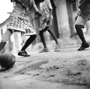 Boys play football on a side street in Cap-Haitien. Haiti 2004