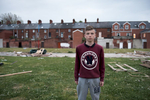 Ryan, 14, in the Village area of south Belfast. Behind him a lamp post in the colors red, blue and white of the Union Jack identifies the area as Protestant.  Flags, murals and painted curbs and lamp posts are common identity markers in Protestant working-class areas.Young working-class youth are growing up in a deeply divided society with an entrenched {quote}us and them{quote} mentality.
