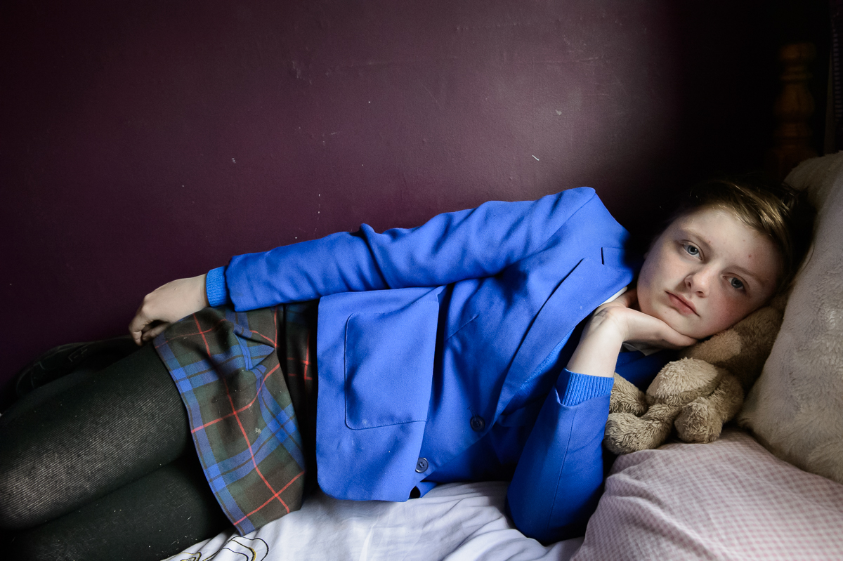 Wearing her school uniform, Demi, 15, lies on her girlfriend Grace's  bed in Catholic Andersontown in west Belfast. Like many other young people Demi thinks politicians are locked in the past. {quote}Politicians were brought up in a society were divisions were really simple: man-woman and Catholic-Protestant. We're not like that anymore.{quote}
