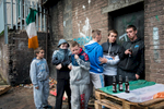 Surrounded by Irish flags, teenagers hang out in the Catholic New Lodge area of north Belfast. The tricolor flag, the national flag of the Republic of Ireland, is a symbol of republicanism. North Belfast is among the most socially and economically deprived areas in northern Ireland. It was also an area that experienced some of the worst violence. A large part of its population has been directly affected by the Troubles and the area remains deeply divided.