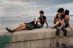 Malecón, Havana   On a Saturday night, seventeen-year-old Adams Balboa, Rachel Ortega, Julio Richard and Beatriz Regla hang out along the Malecón, Havana's seawall, while a cruise ship carrying foreign tourists, is leaving the harbor. The increasing number of tourists coming to the island will likely  increase the division between rich and poor on the island. Cubans, who don't have the money to set up a private business to provide services to the tourists, risk to be left out.