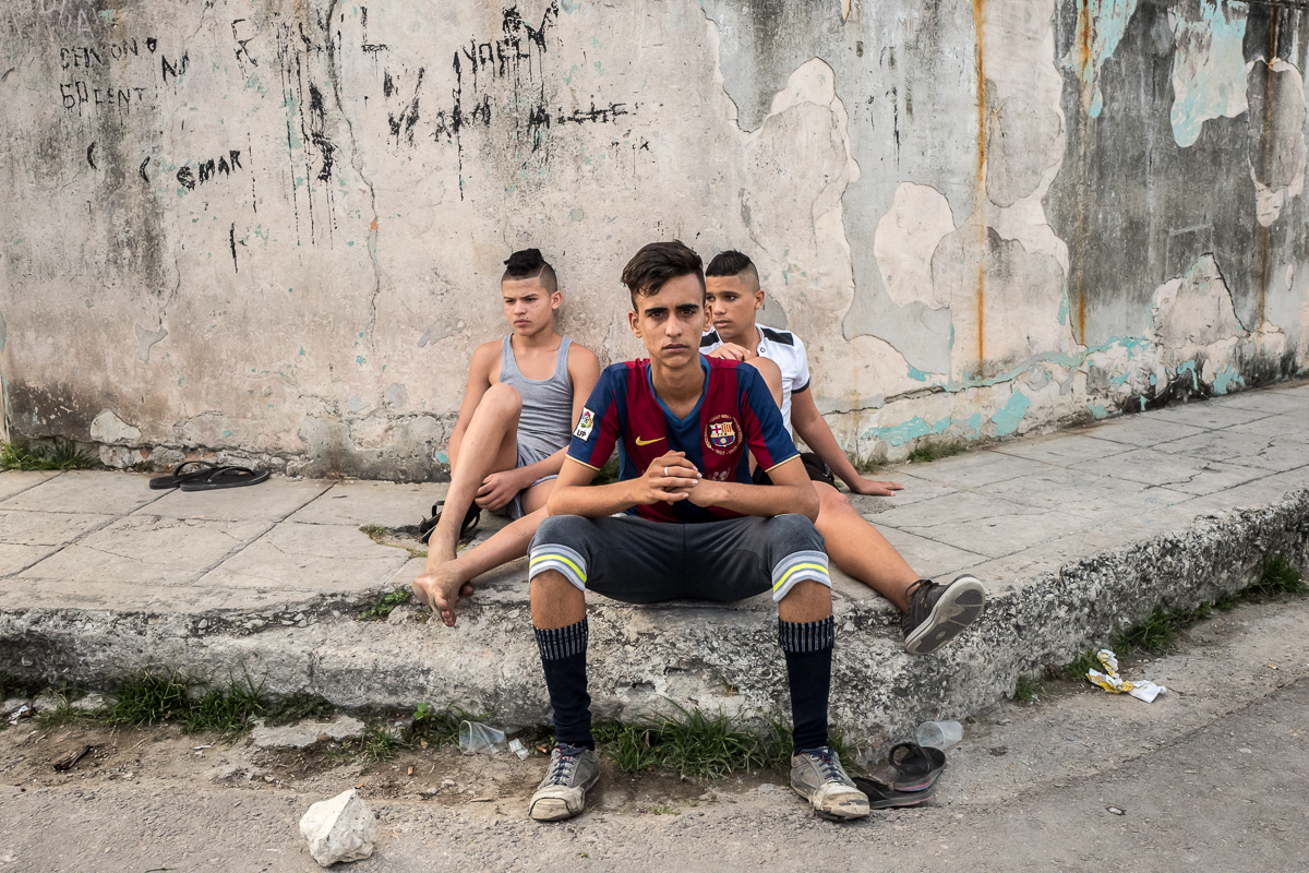 El Canal, Havana    Dariel González Colado (middle), 17, and neighbors Felix (left), 15 and Albaro, 13, sit on a street corner in the poor run-down neighborhood El Canal, one of the rougher neighborhoods in Havana. {quote}That's what we do every day {quote} said Dariel, who studies catering {quote}sit here or play soccer on the street, there is not much else to do{quote}.