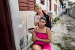 Regla, Havana   Arianna Gusmán Peña , 19, gets her hair dyed by a neighbor in the municipality of Regla. {quote}We don't have much{quote} she said but we have solidarity, we help each other{quote}.