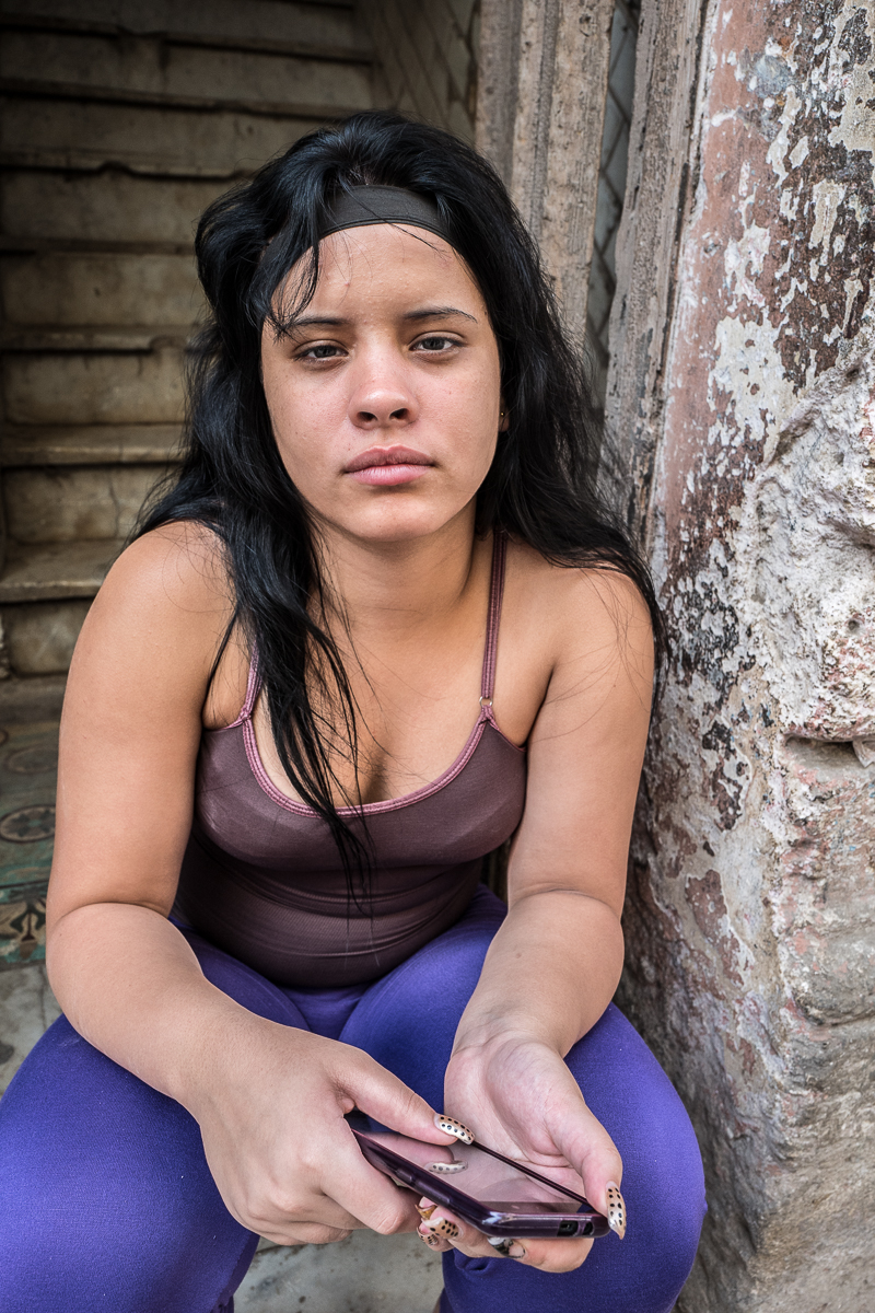 Centro Habana, Havana   Gloria Cespedes Peñalver, 18, who is unemployed, poses for a portrait on the stairs her apartment building in the Centro Habana neighborhood.  Economic reforms have left disproportionally more women out of work.