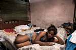 El Canal, Havana   Nieve De La Caridad Fraga, 14, lies on a bed in the cramped house she shares with 8 other family members in El Canal, a shabby low-income neighborhood.