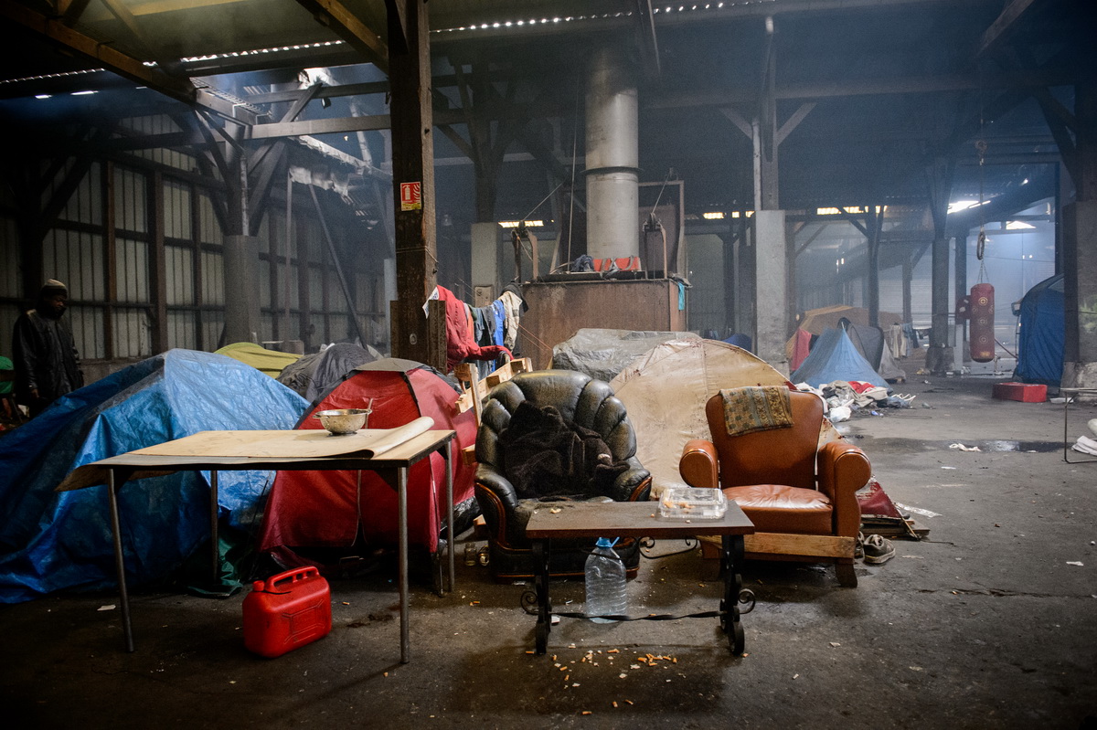 Calais, December 2014 Inside the Galoo squat, a large abandoned metal recycling plant, housing hundreds of migrants.