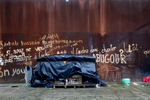 Calais, December 2014 A makeshift shelter made of plastic sheeting and packing crates stands on the site of Galoo squat, an abandoned metal recycling plant.