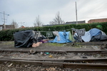 Calais, February 2014 Tents stand on a disused railway line in Calais just beside the main port from where ferries leave for the UK. The tents are reinforced against the elements by plastic sheets, tarpaulins, wooden pallets and railway line ballast. In May 2014, police used bulldozers to dismantle three makeshift camps around the town, claiming that an outbreak of scabies threatened public health. Since then, several new camps have sprung up to shelter the refugees and migrants who keep arriving in increasing numbers.