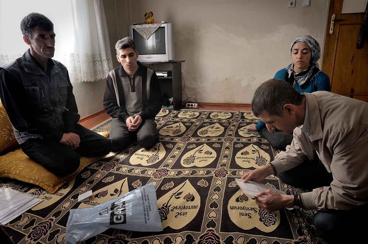 On a visit to his brother Mehmet Basak, Bekir looks at a medical report. Mehmet worked alongside his brother in a sandblasting workshop in Istanbul and now also suffers from silicosis. Another brother who also worked as a sandblaster already died of silicosis.