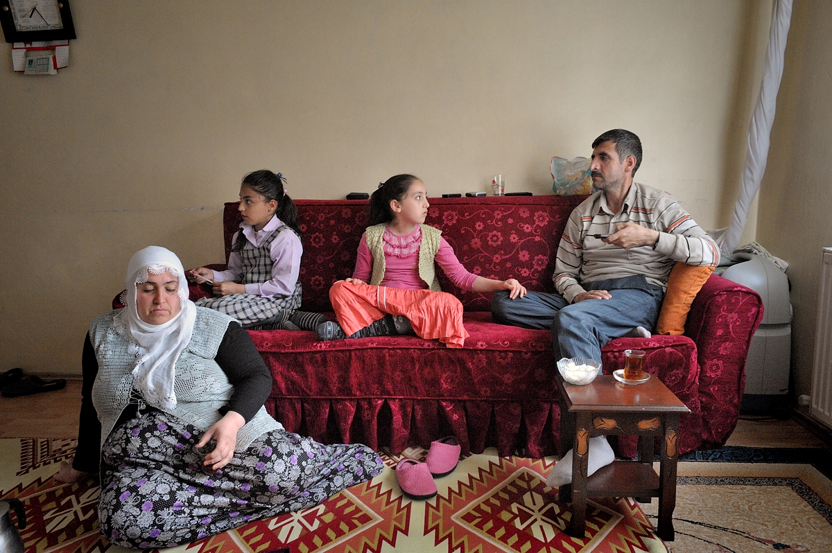 Confined to his apartment because of his disease, Bekir spends most of his days on the sofa.  Here he drinks tea surrounded by his wife Zeynab, daughter Tugba and her friend.