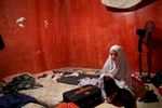 Marwa Hazineh (13) sits in the windowless bedroom that she shares with her parents and two siblings. When the family fled Syria, they could only bring a few suitcases with belongings.