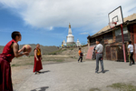 Young Buddhist monks play basketball with local teenage boys at the Dambadarja monastery, located in the north-eastern suburbs of UB. The monastery was among the 1000 Buddhist temples and monasteries that were destroyed or damaged between 1937 and 1939 by Soviet and Mongolian authorities as a supplement to the Soviet Great Purge under Stalin.  After the communist period ended, Buddhism, Mongolia’s main religion has experienced a strong resurgence.