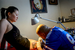Angie, 24, who until recently lived in Hungary, gets a gun tattoo at Bandgaa’s tattoo parlor in UB.  Mongolia’s boom has been a magnet to some who left the country years ago.