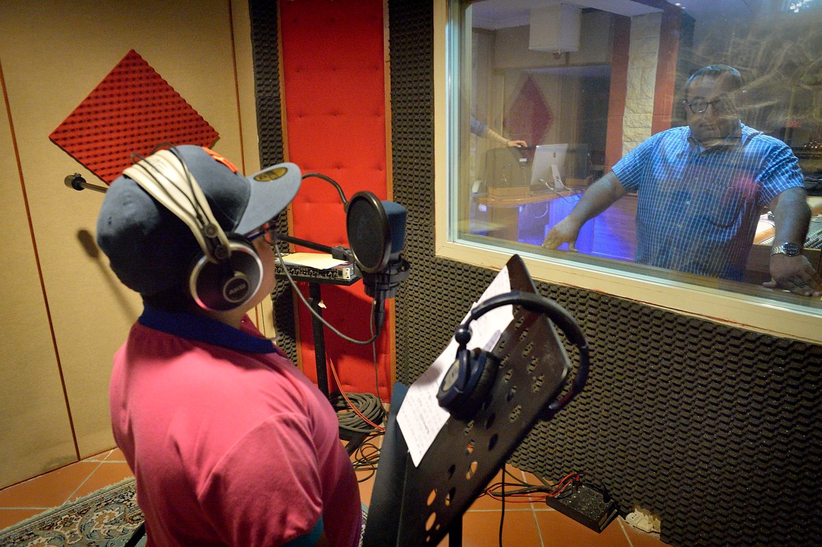 Since starting out two years ago, Lucio has recorded two CDs. Here is seen in the recording studio while his father-manager Gaetano looks on.