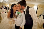 Sasà (11) is kissed by the bride and groom at a wedding celebration held in a lavish banquet hall in Trecase, at the foot of Mount Vesuvius. At a wedding it is not rare to have a succession of both adult and child singers.