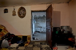 The damp basement room in the mahalla Botes/Shtatore in Peja, where the five members of the Haxhija family live.