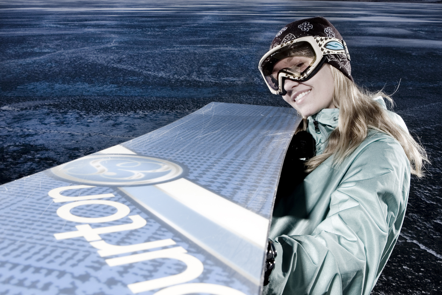Portraits of Erika Skogg with her snowboard on a frozen Canyon Ferry Lake near Townsend, Montana