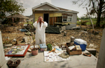 Untitled - Steve Minyard (cq) stands in the place where his house once stood September 16, in Meraux, La.  Spread out on stoop are all the items which he could salvage from the wreckage left after the wind and flooding of Hurricane Katrina.  Among the keepsakes Minyard was especially intent on finding were pictures of his sister who died little over a year ago.  Minyard shared the house in St. Bernard Parish with his fiancee Jessica Marques Piazza and the two had returned Friday to gather their belongings.  {quote}To some people this doesn't seem like much,{quote} Piazza said.  {quote}But this is all I had.  All I had.{quote}  The couple does not have any insurance.