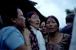 6 heure du matin, le jour du grand départ: les proches de la famille Mainali se rassemblent devant leur hutte pour leur souhaiter un bon voyage. Ici les femmes déposent sur le front de Hema la tika (rituel Hindou). Népal, Août 2009, Népal.