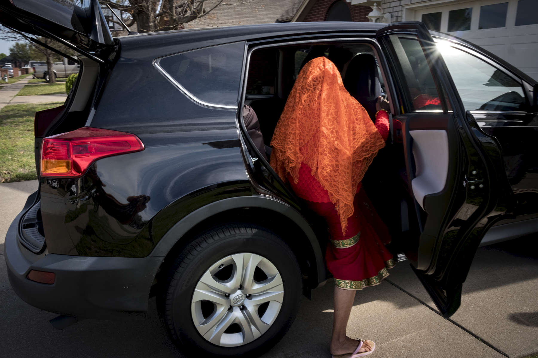 Radika Mainali monte dans la voiture familliale pour aller rendre visite à de la famille. Watauga, Etats-Unis, Mars 2018.
