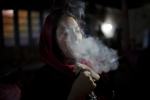 Farkhonda smoking chicha in Kabul, Afghanistan. November 2012.