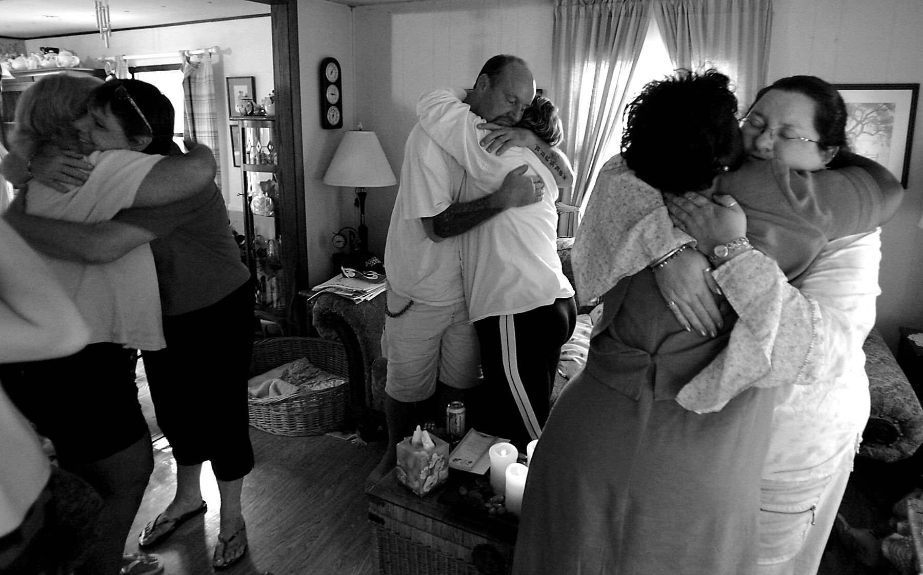 Family members hug with friends after Pat's service.