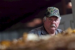 Farmer Shelley Johnson of Aynor, South Carolina watches as his tobacco is weighed and checked for moisture content at the Big L Warehouse in Mullins, South Carolina July 29, 2013. The cooperative US Tobacco sets the standard for pricing and quality of area farmer's crop at this warehouse. The traditional tobacco harvest requires many labor intensive hours to bring the crop to market, especially with the flue-cured variety prominent in the southern United States. With the growing health concerns with smoking in the US, most farmers use market cooperatives to sell their crop to the growing markets in China.      Picture taken on July 29, 2013.   REUTERS/Randall Hill (UNITED STATES)