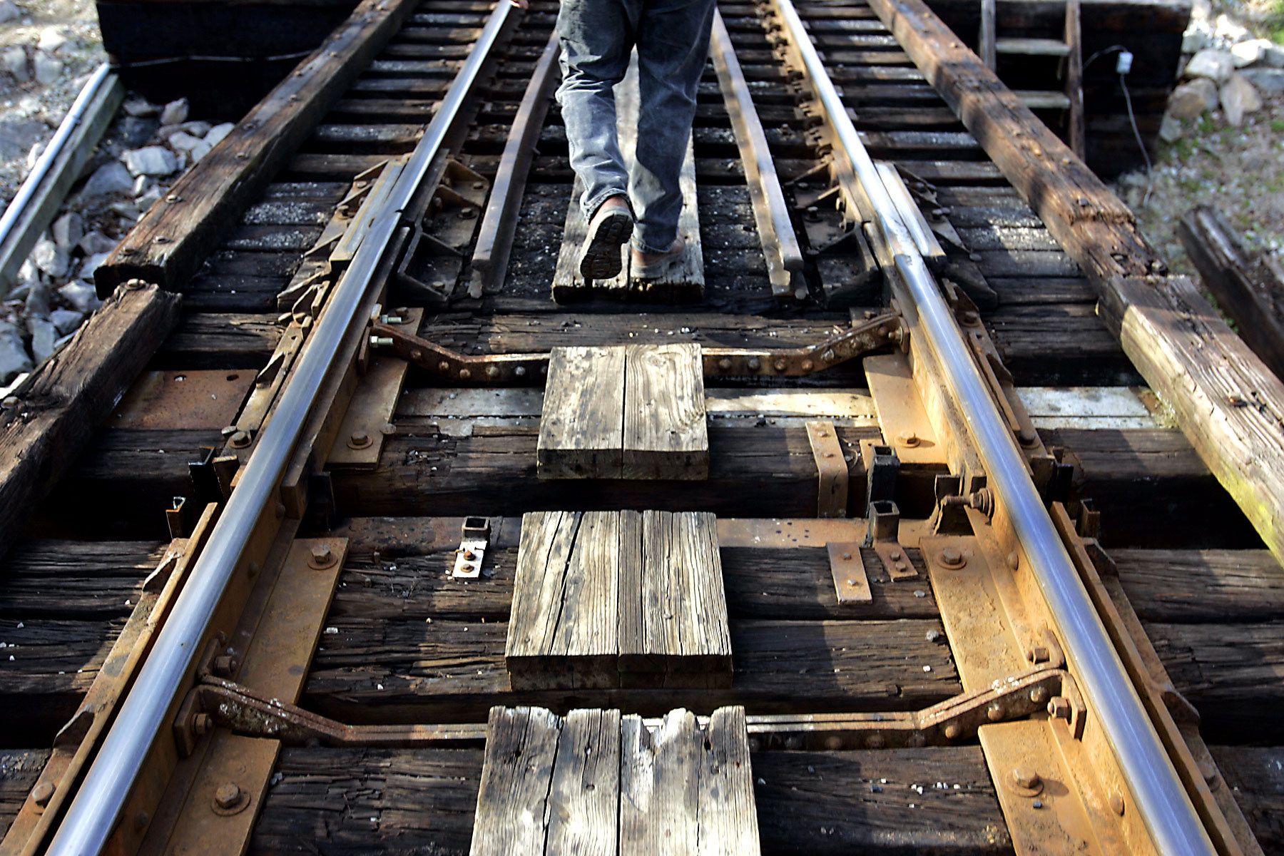 Conductor Jerry Stevens walks the foot path while checking the connections of the Waccamaw River Swing Bridge before a train's crossing to Myrtle Beach. The Conway Southern Railroad is the only trainline in the Grand Strand.