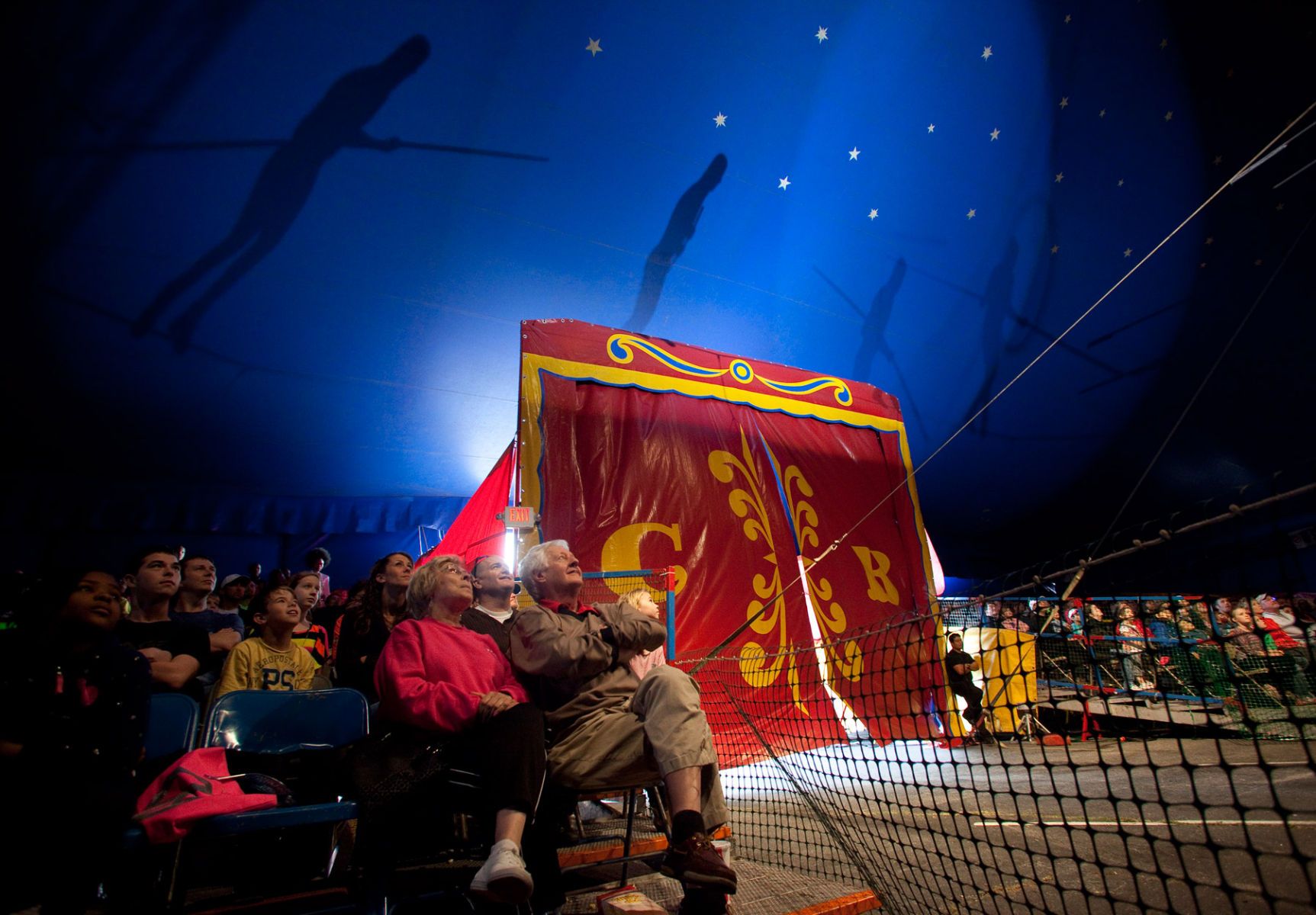 Patrons watch as the Tabares High Wire troupe performs at the Cole Brothers Circus of the Stars in Myrtle Beach, South Carolina March 31, 2013. Traveling circuses such as the Cole Brothers Circus of the Stars, complete with it's traveling big top tent, set up their tent city in smaller markets all along the East Coast of the United States as they aim to bring the circus to rural areas. The Cole Brothers Circus, now in its 129th edition, travels to 100 cities in 20-25 states and stages 250 shows a year.   REUTERS/Randall Hill   (UNITED STATES)