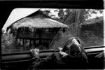 Tucked in Thailand's northern border, Maesalong is a place of contrasts. It's a freedom mecca from it's oppressive neighbors in China, Laos and Burma. Caught between are the Akha tribal people who have been forced from their nomadic tradition because of politics and strict borders. This photo: Ahbu travels in the back of a truck from her home in Maesalong, Thailand to Chiang Rei to receive treatments for her opium addiction. Having ridden in an automobile only once in her life, the hour-long journey has made her sick.