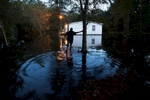 Lewis Johnson makes his way to help a neighbor remove valuables from a flooded home on Frank Williams Road in Georgetown, South Carolina October 8, 2015. South Carolina's governor warned on Thursday that several coastal areas were about to be hit by a second round of major flooding, while residents inland hauled soaked furniture and appliances from homes left in ruins by unprecedented rainfall.  REUTERS/Randall Hill