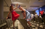 Sisters Sophia (L) and Norah Boice of North Charleston play on the seats after U.S. Democratic presidential candidate and former Secretary of State Hillary Clinton spoke at a rally at Trident Technical College Conference Center in North Charleston, South Carolina June 17, 2015.   REUTERS/Randall Hill