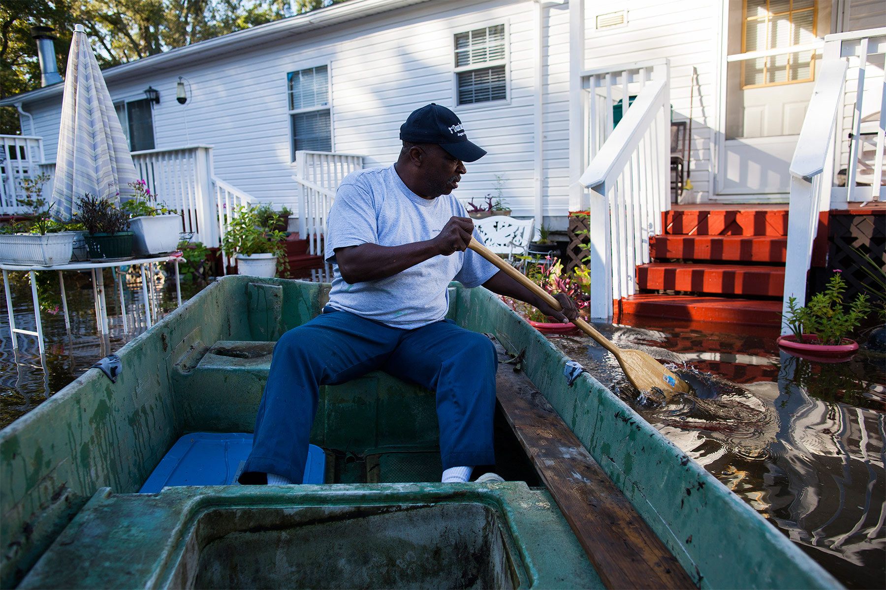 Arthur Linden uses a johnboat to survey the flooded areas of his brother's property along Dunbar Road in Georgetown, South Carolina October 8, 2015. Flooding from historic rainfall in South Carolina claimed two more lives on Wednesday, and the threat of further inundation from swollen rivers and vulnerable dams put already ravaged communities on edge.  REUTERS/Randall Hill