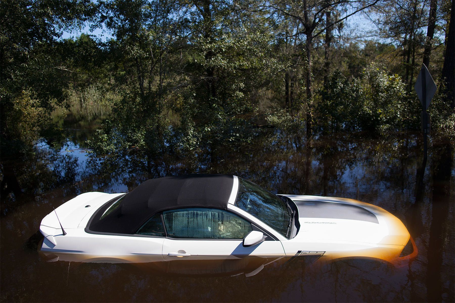 A car that was stranded is submerged in flood waters along Lee's Landing Circle in Conway, South Carolina October 7, 2015. Rescuers searched early Wednesday for two people missing in floodwaters in South Carolina, while authorities urged residents in hundreds of homes to seek higher ground. REUTERS/Randall Hill