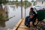 Chris Stubo watches the flood waters that surround his home on Apllewood Court in Myrtle Beach, South Carolina October 5, 2015. Torrential rainfall that South Carolina's governor called a once-in-a-millennium downpour triggered flooding in the southeastern U.S. state on Sunday, causing at least eight deaths in the Carolinas. The storm had dumped more than 20 inches (50 cm) of rain in parts of central South Carolina since Friday, the National Weather Service said. The state climatologist forecast another 2 to 6 inches (5 to 15 cm) through Monday as the rain began to slacken. REUTERS/Randall Hill