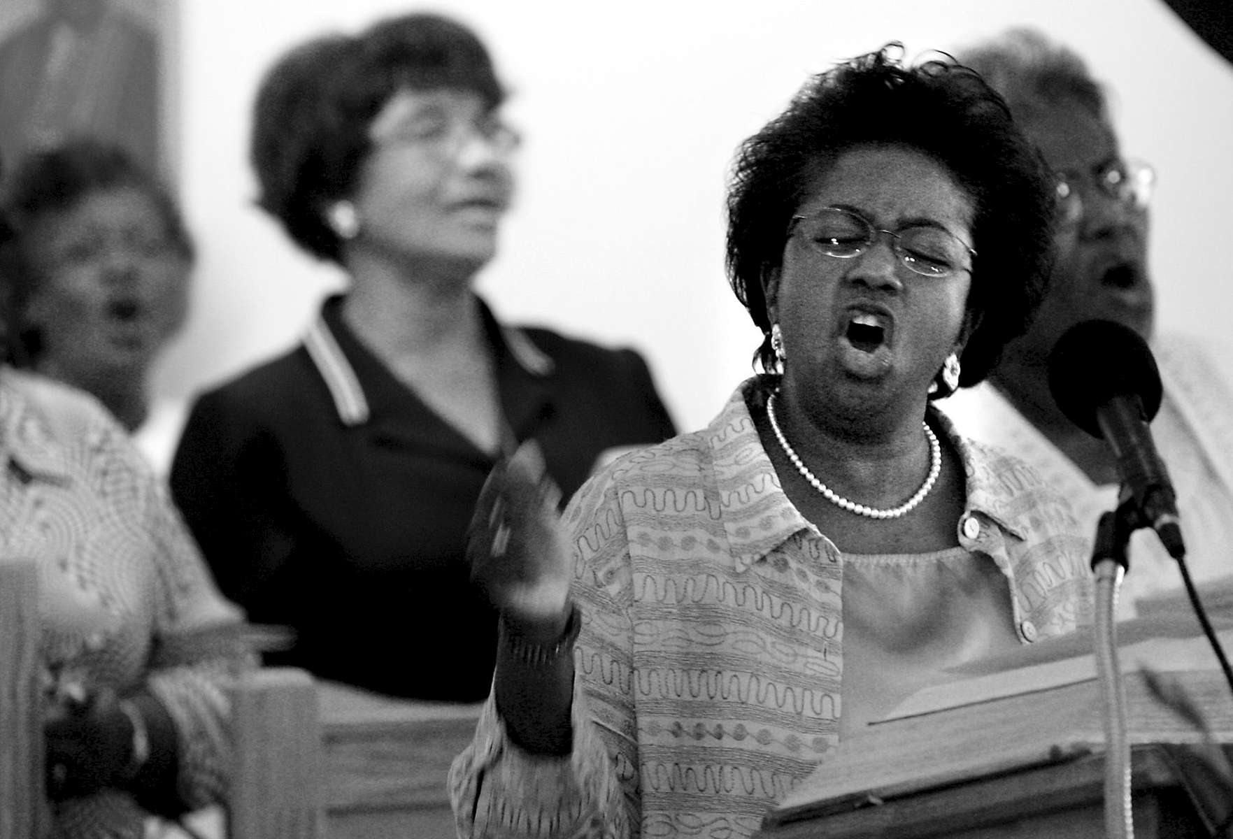 The Rev. Cheryl Adamson, and members of the St John choir, sing {quote}I Am Free{quote} during Pat's memorial service.