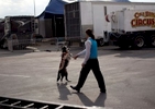Cole Brothers Circus of the Stars performer German Fassio works with a dog backstage before the start of the first show in Myrtle Beach, South Carolina March 31, 2013. Traveling circuses such as the Cole Brothers Circus of the Stars, complete with it's traveling big top tent, set up their tent city in smaller markets all along the East Coast of the United States as they aim to bring the circus to rural areas. The Cole Brothers Circus, now in its 129th edition, travels to 100 cities in 20-25 states and stages 250 shows a year.   REUTERS/Randall Hill   (UNITED STATES)